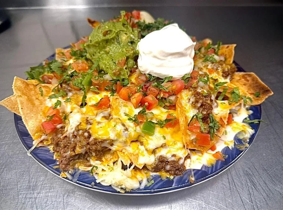Trashcan Nachos piled with cheese, asada, pico and guacamole